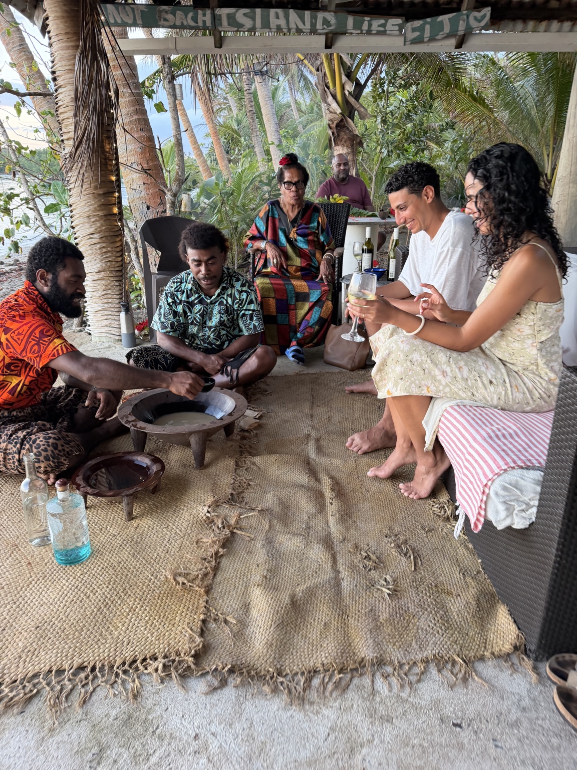Guests sharing a traditional kava experience with local hosts